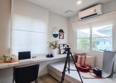 Home office with window, desk, chair, and decor