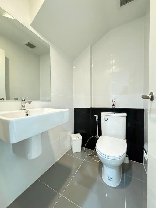 Modern bathroom with white ceramic sink and toilet