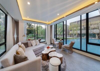 Spacious living room with large windows and a pool view