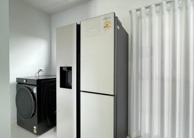 Modern laundry room with fridge and washing machine