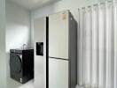 Modern laundry room with fridge and washing machine