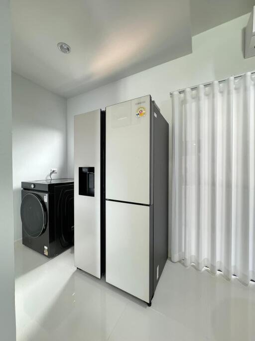 Modern laundry room with fridge and washing machine