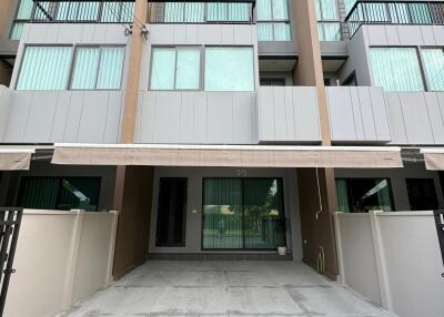 Modern townhouse exterior with driveway