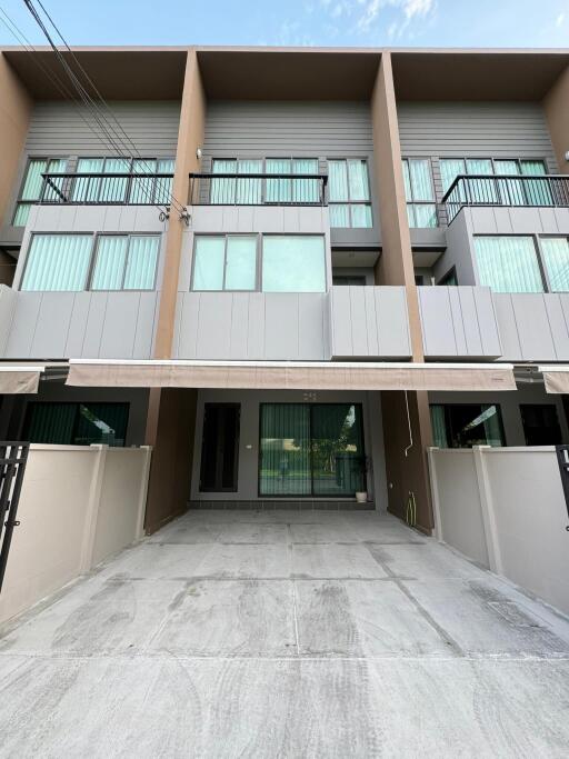 Modern townhouse exterior with driveway