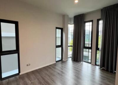 Spacious living room with large windows and modern lighting