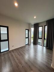 Spacious living room with large windows and modern lighting