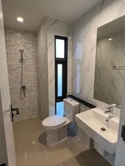 Modern bathroom with a walk-in shower and large mirror