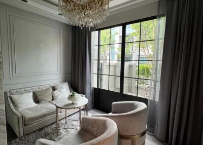 Elegant living room with chandelier and large window