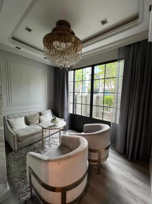 Elegant living room with chandelier and large window