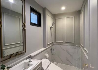 Modern bathroom with large mirror and contemporary fixtures