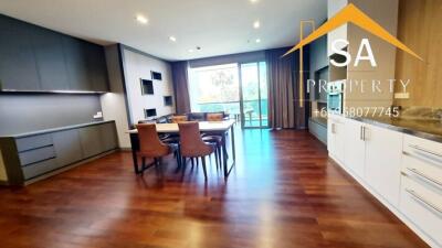 Modern living and dining area with wooden flooring and large windows