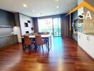 Modern living and dining area with wooden flooring and large windows