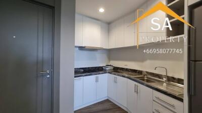 Modern kitchen with white cabinets and built-in appliances