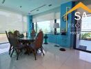 Spacious dining area with glass-top table and wicker chairs