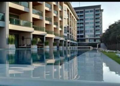 Modern building with swimming pool and sun loungers