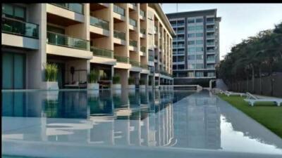 Modern building with swimming pool and sun loungers