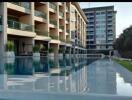 Modern building with swimming pool and sun loungers