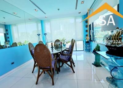 Bright dining room with large windows and blue wall accents