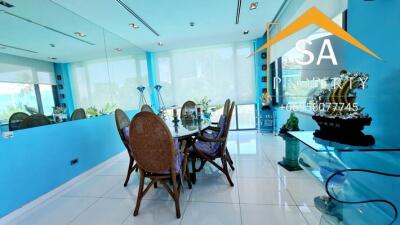 Bright dining room with large windows and blue wall accents