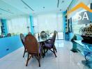 Bright dining room with large windows and blue wall accents