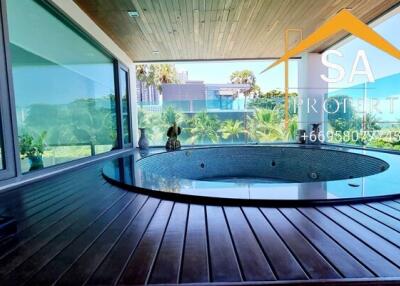 Bathroom with large indoor jacuzzi and scenic view