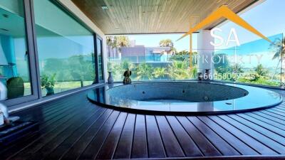 Bathroom with large indoor jacuzzi and scenic view