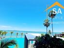 Sea view from a luxury property with palm trees and a pool