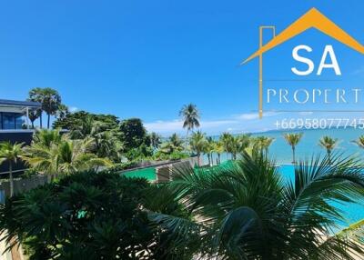 Scenic view of a tropical outdoor area with a swimming pool and ocean backdrop