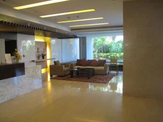 Modern building lobby with seating area and large windows