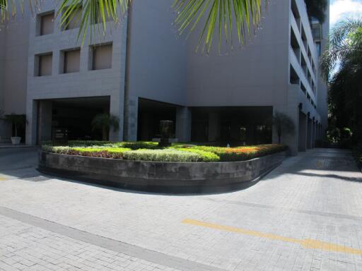 Exterior view of a modern building entrance with landscaped garden