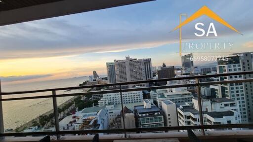 View from the balcony overlooking the city and ocean at sunset