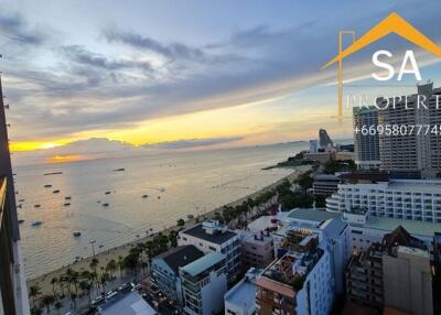 aerial view of a beachfront property at sunset