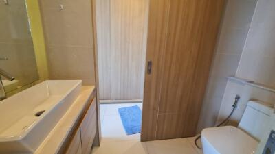 Modern bathroom with wooden sliding door and white fixtures