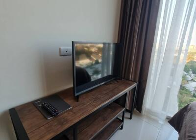 Bright bedroom with television and a view