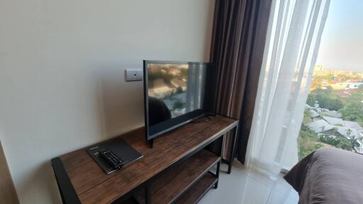 Bright bedroom with television and a view