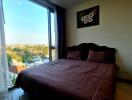 Bedroom with large window and a view