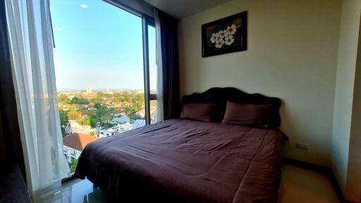 Bedroom with large window and a view