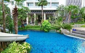 Outdoor view of a landscaped area with a pool and slide