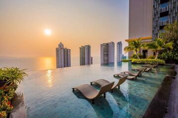 Infinity pool with city and sunset view