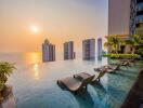 Infinity pool with city and sunset view