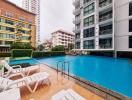 Outdoor swimming pool area with buildings in the background