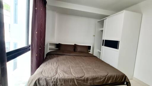 Cozy bedroom with brown bedding and white wardrobe