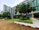 Modern residential building exterior with landscaped greenery