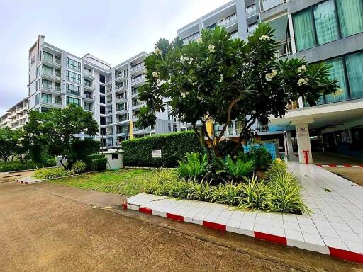 Modern residential building exterior with landscaped greenery