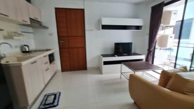 living area with kitchen and balcony