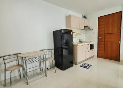 Modern kitchen with dining table and refrigerator