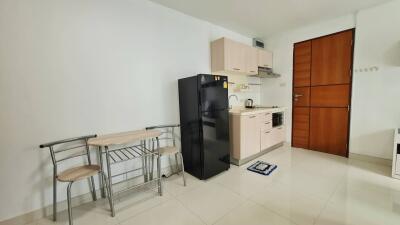 Modern kitchen with dining table and refrigerator