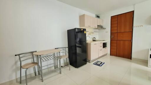 Modern kitchen with dining table and refrigerator