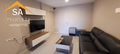 Modern living room with sofa and wall-mounted TV