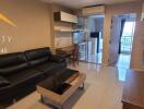 Living room with black leather sofa and modern furniture